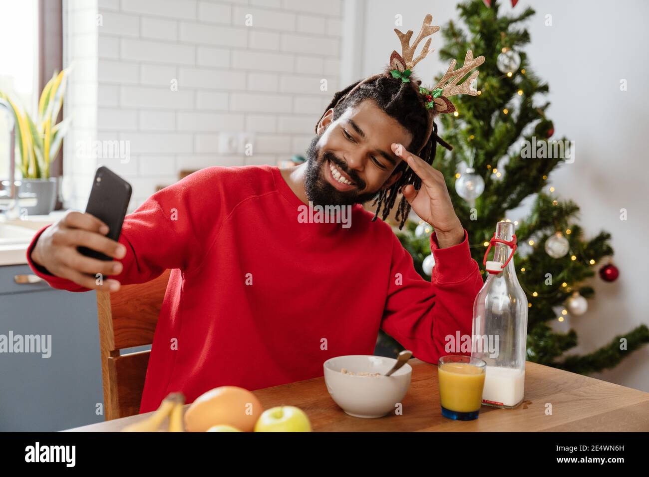 Joyful African American Man Smiling While Taking Selfie On Cellphone In 