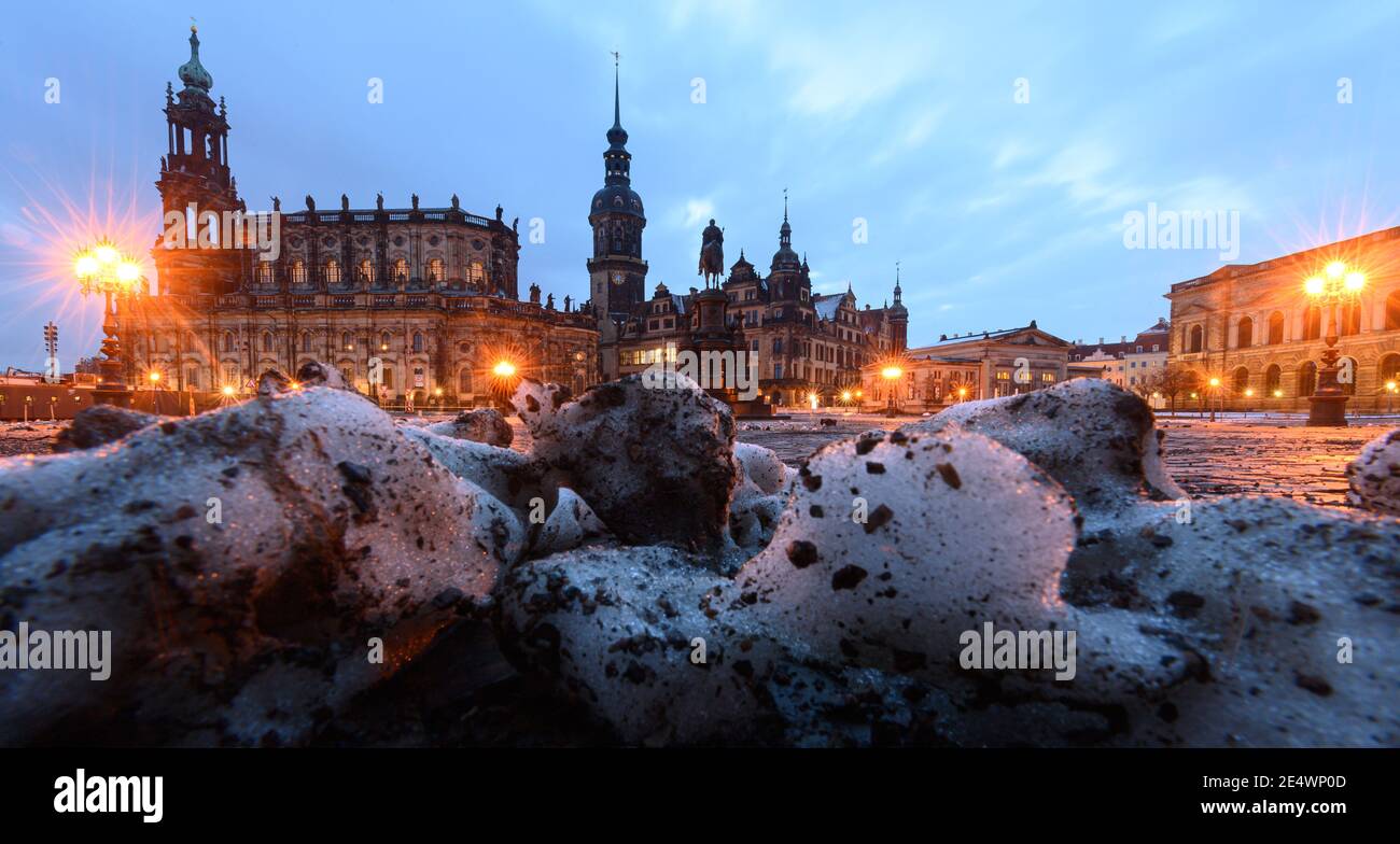 Dresden, Germany. 25th Jan, 2021. Remnants of snow lie in the morning on the Theaterplatz in front of the Hofkirche (l-r), the equestrian statue of King Johann, the Hausmannsturm, the Residenzschloss, the Schinkelwache and the Zwinger. Credit: Robert Michael/dpa-Zentralbild/dpa/Alamy Live News Stock Photo
