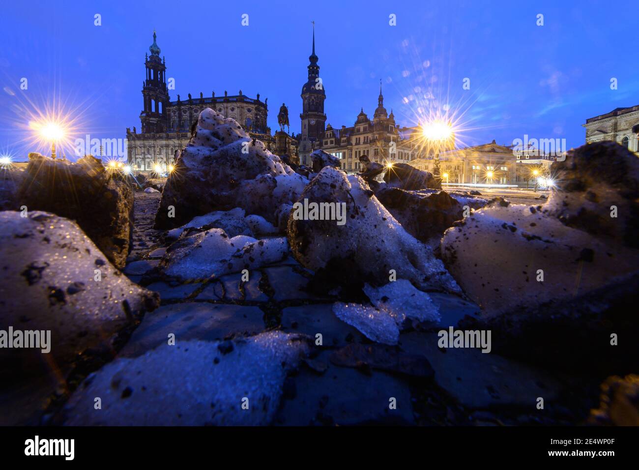Dresden, Germany. 25th Jan, 2021. Remnants of snow lie in the morning on the Theaterplatz in front of the Hofkirche (l-r), the equestrian statue of King Johann, the Hausmannsturm, the Residenzschloss, the Schinkelwache and the Zwinger. Credit: Robert Michael/dpa-Zentralbild/dpa/Alamy Live News Stock Photo