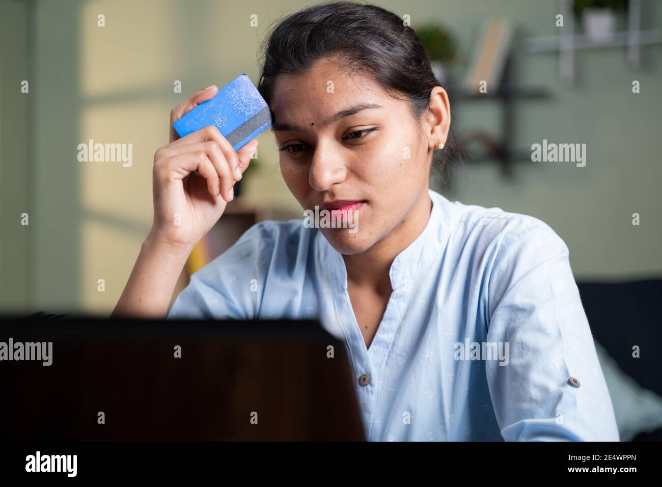 Worried Young business woman while doing online payment thorough credit