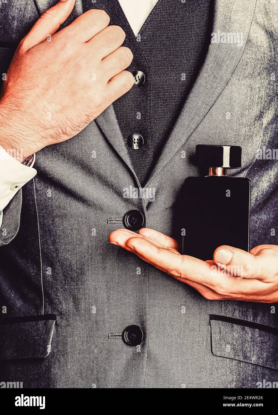 Fragrance smell. Men perfumes. Fashion cologne bottle. Man holding up