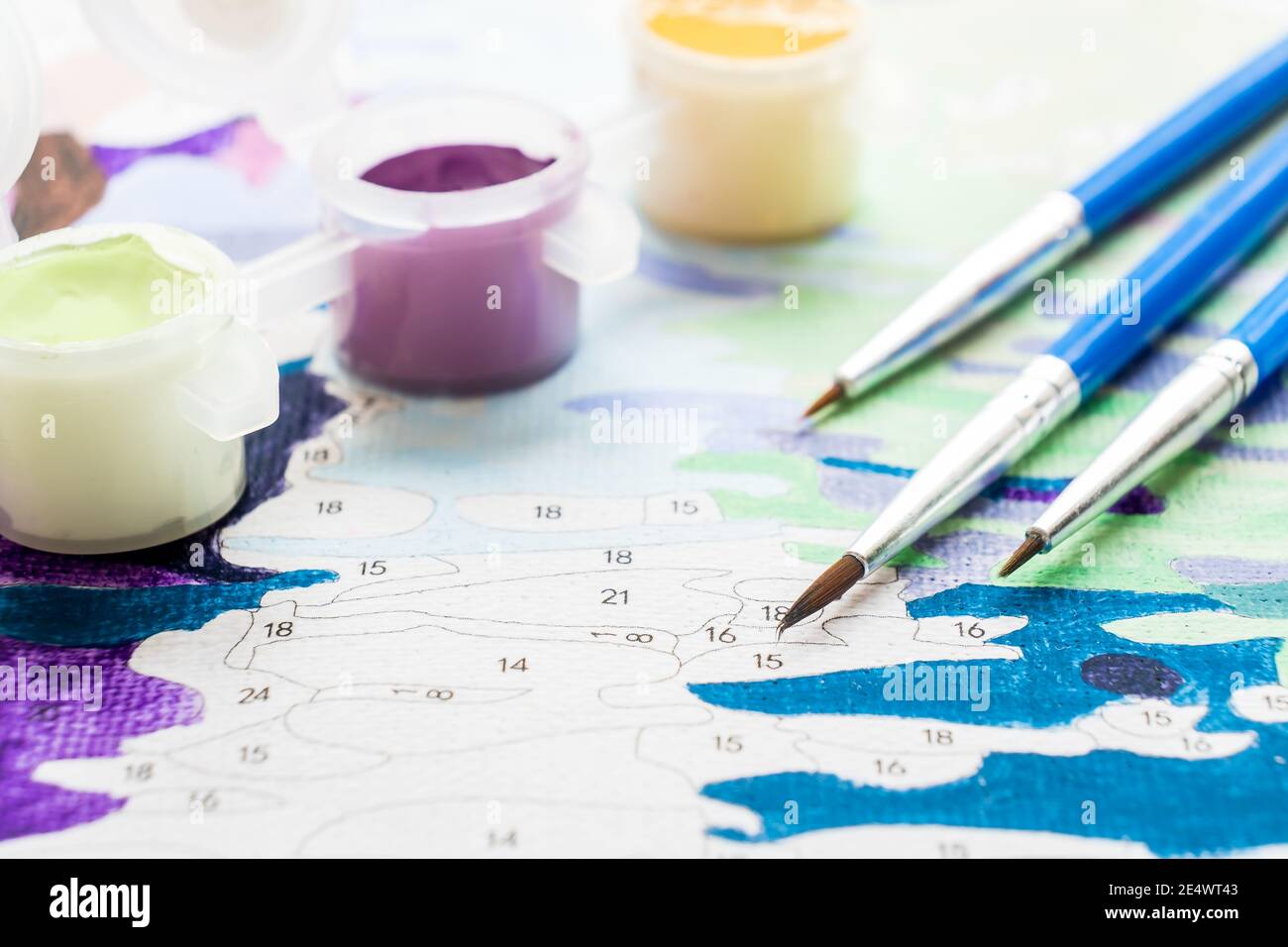 https://c8.alamy.com/comp/2E4WT43/the-artists-brush-and-multi-colored-paint-for-painting-on-the-coloring-by-numbers-top-view-of-the-table-2E4WT43.jpg