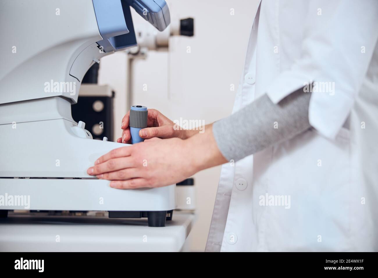 Focused image of experienced doctor looking lens in patient eyes with ...