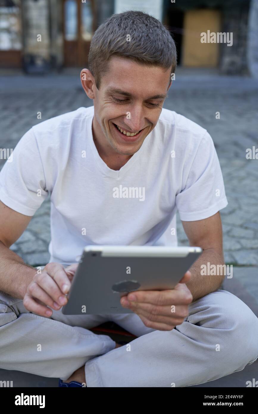 Serious young male executive using digital tablet Stock Photo