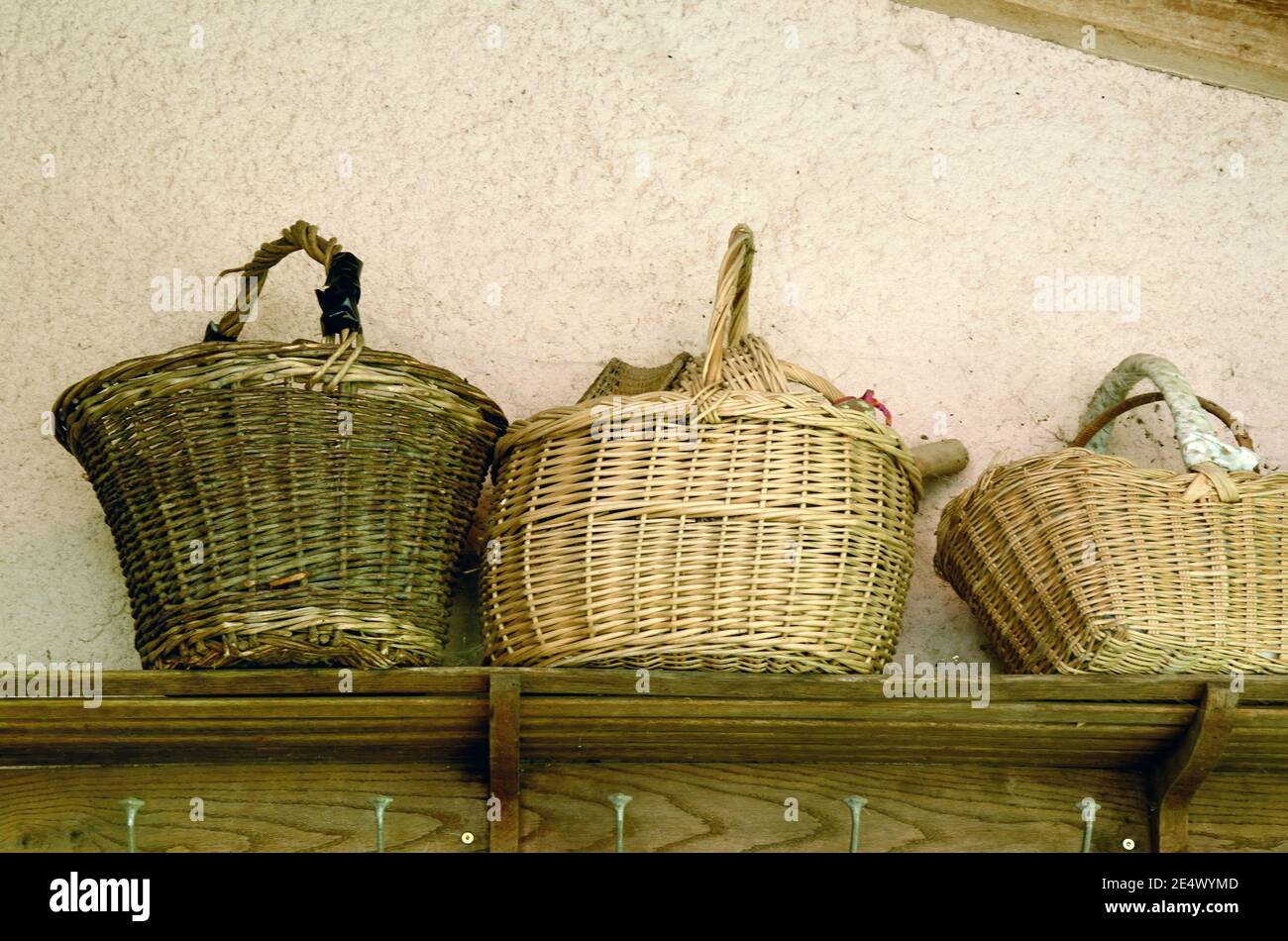 Display of Old Wicket Baskets or Wickerwork Baskets on Wooden Shelf Stock Photo