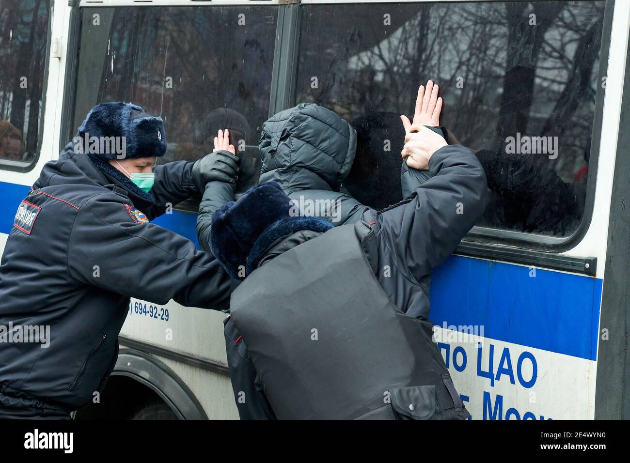 Moscow, Russia. 23rd Jan, 2021. Police search a detained protester near the paddy wagon during the protests.Rallies were held in the largest cities of Russia in support of the opposition leader Alexei Navalny, who was sent into custody after returning to Russia from Germany on suspicion of evading the control of the FSIN (Federal Penitentiary Service). The actions were accompanied by arrests on an unprecedented scale. Credit: SOPA Images Limited/Alamy Live News Stock Photo