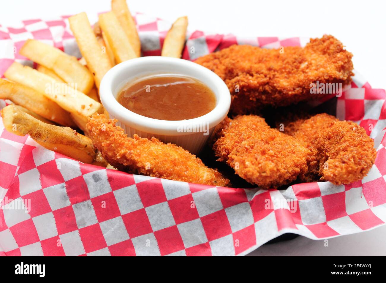 breaded chicken strips with french fries and dipping sauce in a Stock