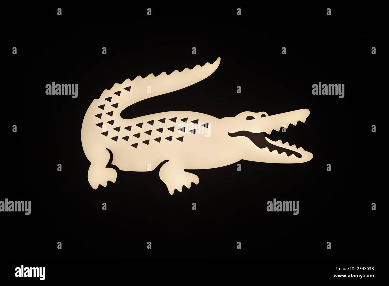 21.01.2021, Singapore, Republic of Singapore, Asia - Illuminated company logo of the iconic brand and fashion label Lacoste with the famous crocodile. Stock Photo