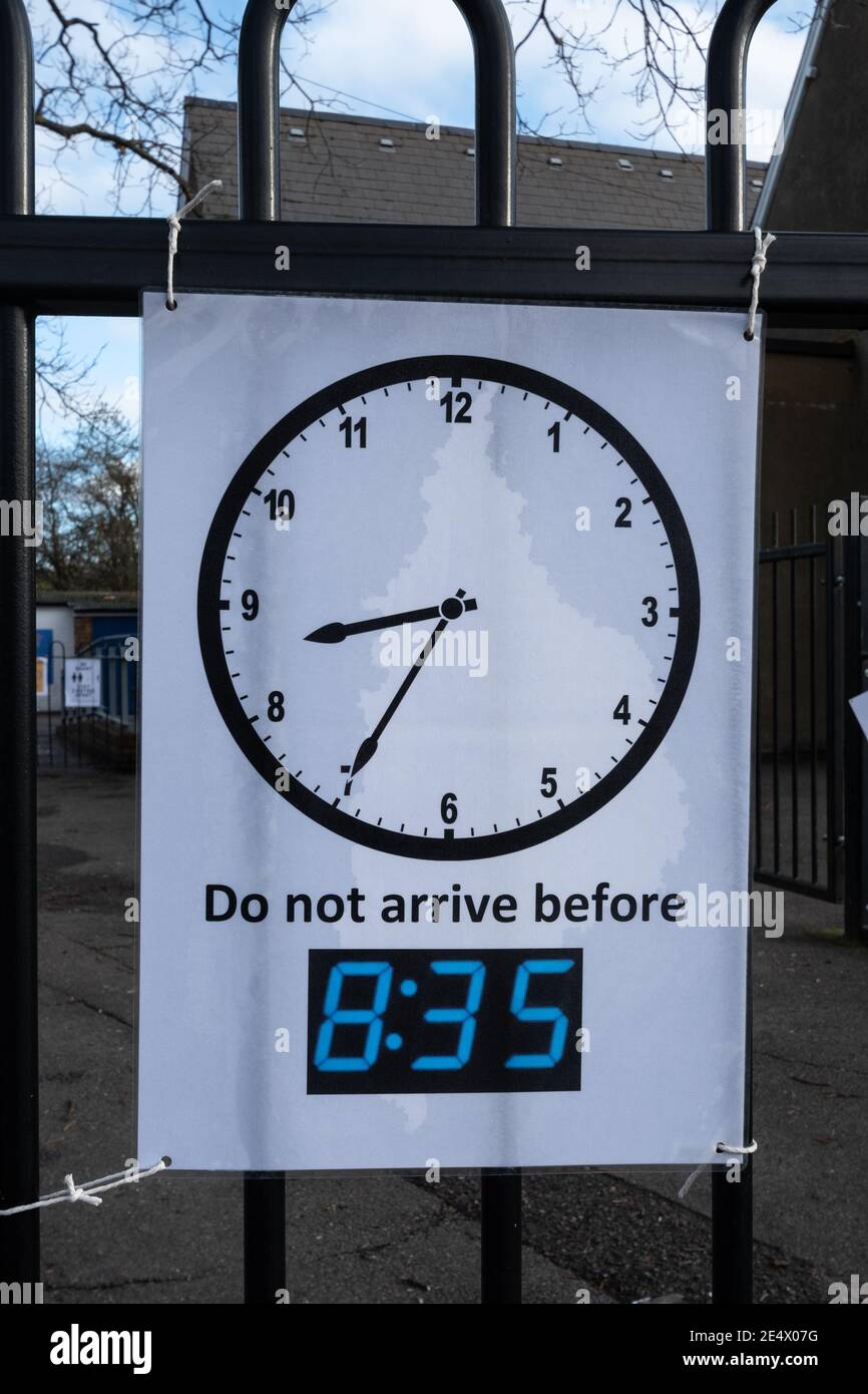 Sign at a UK junior school during the coronavirus covid-19 pandemic advising people not to arrive before 8.35 in the morning Stock Photo