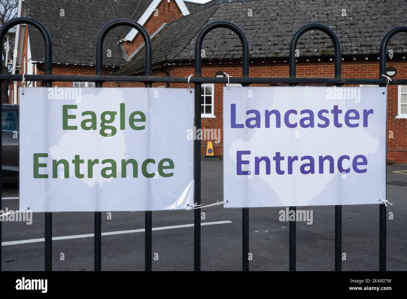 Signs at a UK junior school during the coronavirus covid-19 pandemic, meeting places at entrance for different groups or classes Stock Photo