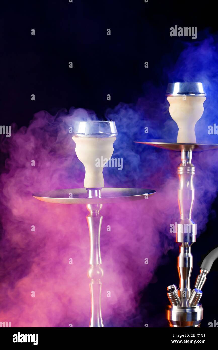 Modern hookah with smoke in dark club light Stock Photo Alamy