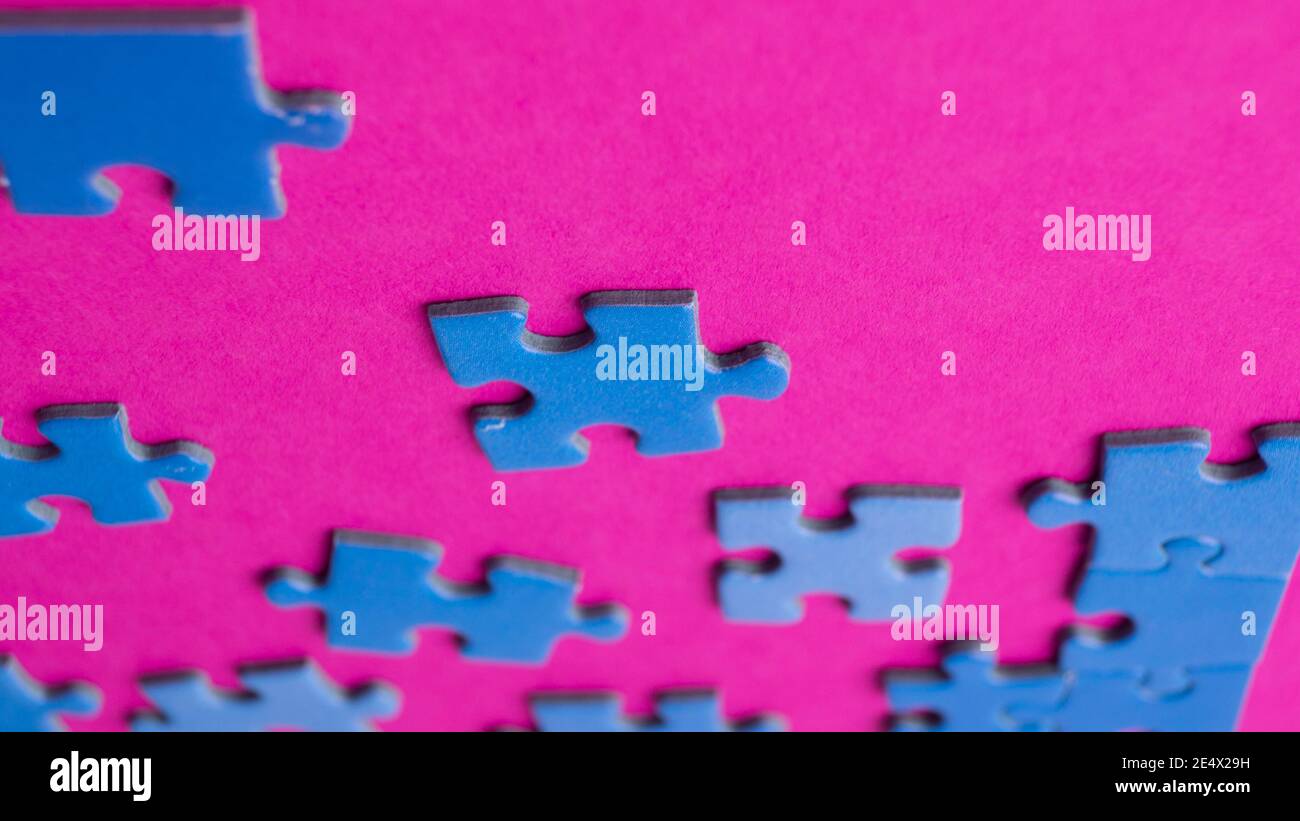 scattered puzzle pieces on colored background Stock Photo
