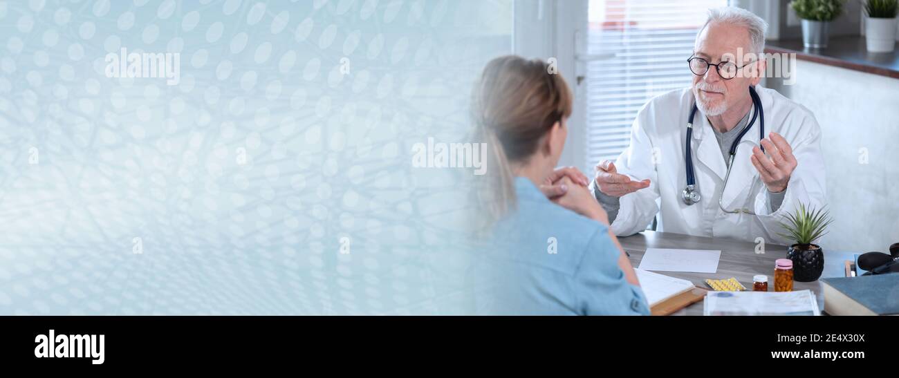 Senior doctor having a discussion with his female patient in medical ...
