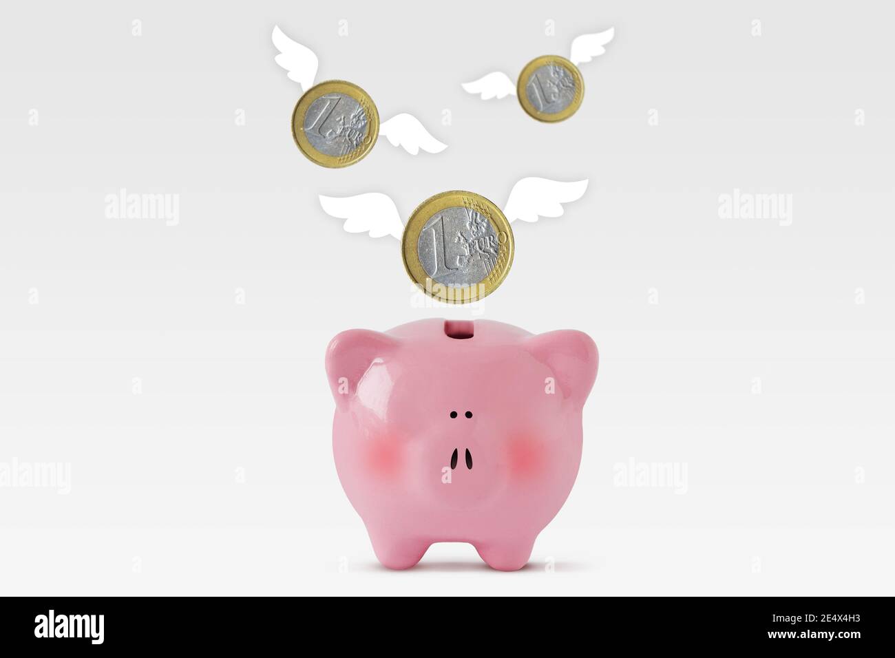 Piggy bank with euro coins flying away - Concept of economy and loss of money Stock Photo