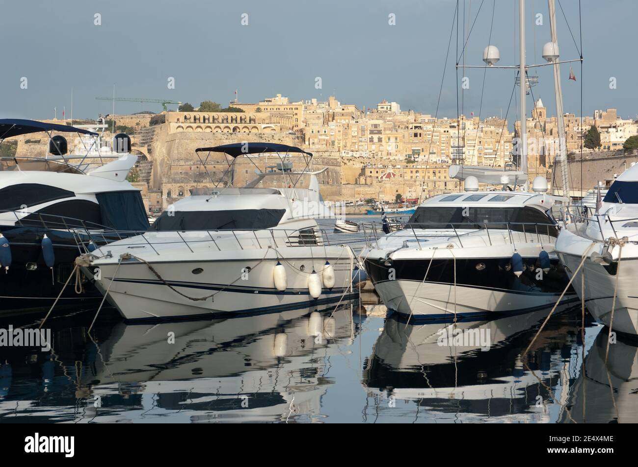 luxury boats moored on background the old town of Senglea, Malta Stock Photo