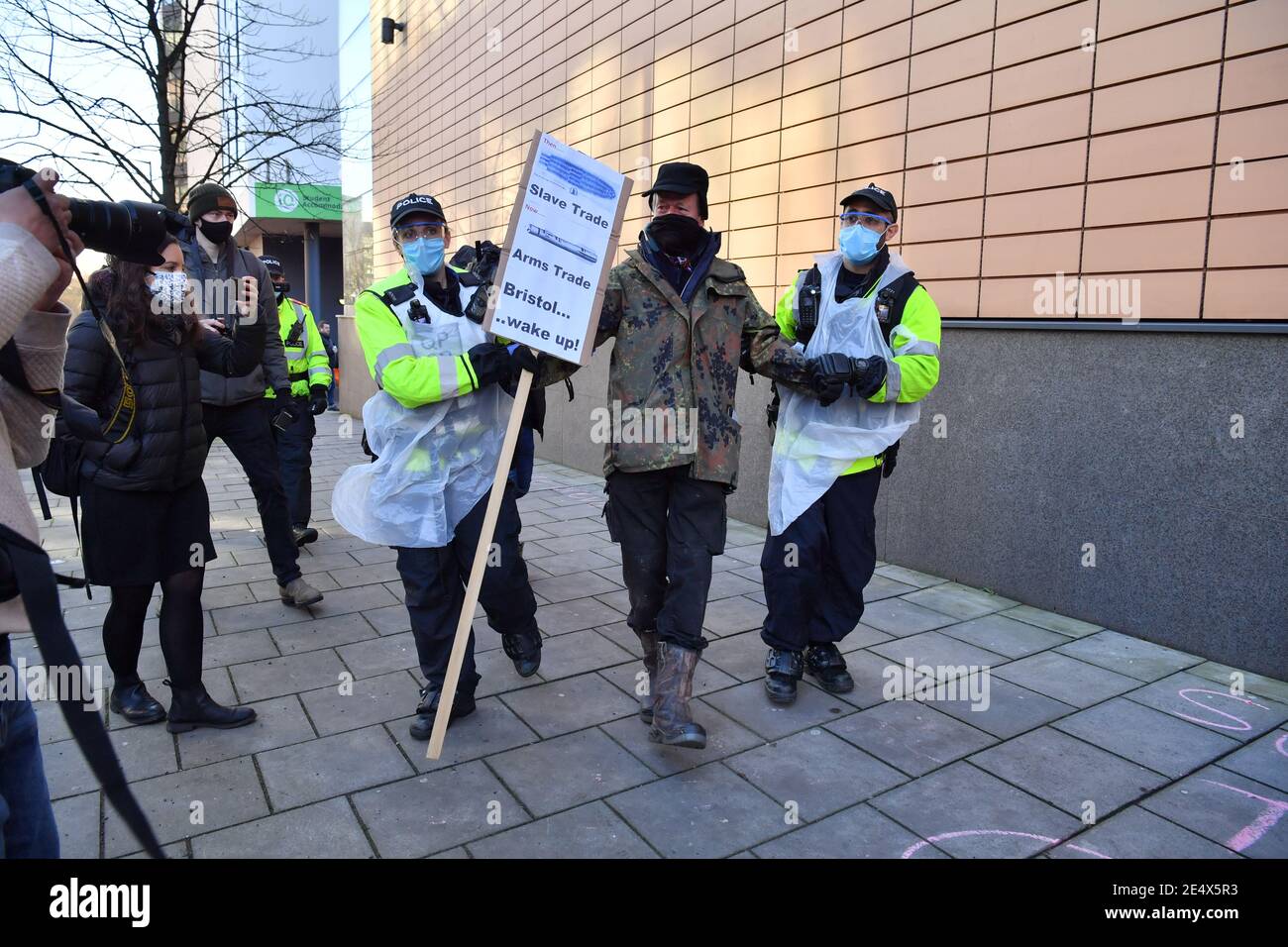 A protester is led away outside Bristol Magistrates' Court, where Rhian Graham, Milo Ponsford, Jake Skuse and Sage Willoughby are due to appear charged with criminal damage over the toppling of the Edward Colston statue in Bristol during the Black Lives Matter protests in June last year. Picture date: Monday January 25, 2021. Stock Photo