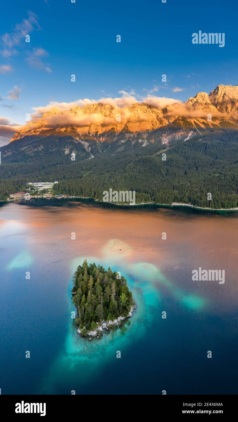 Aerial drone shot of Alpenglow with fog on Zugspitze by Eibsee lake in ...