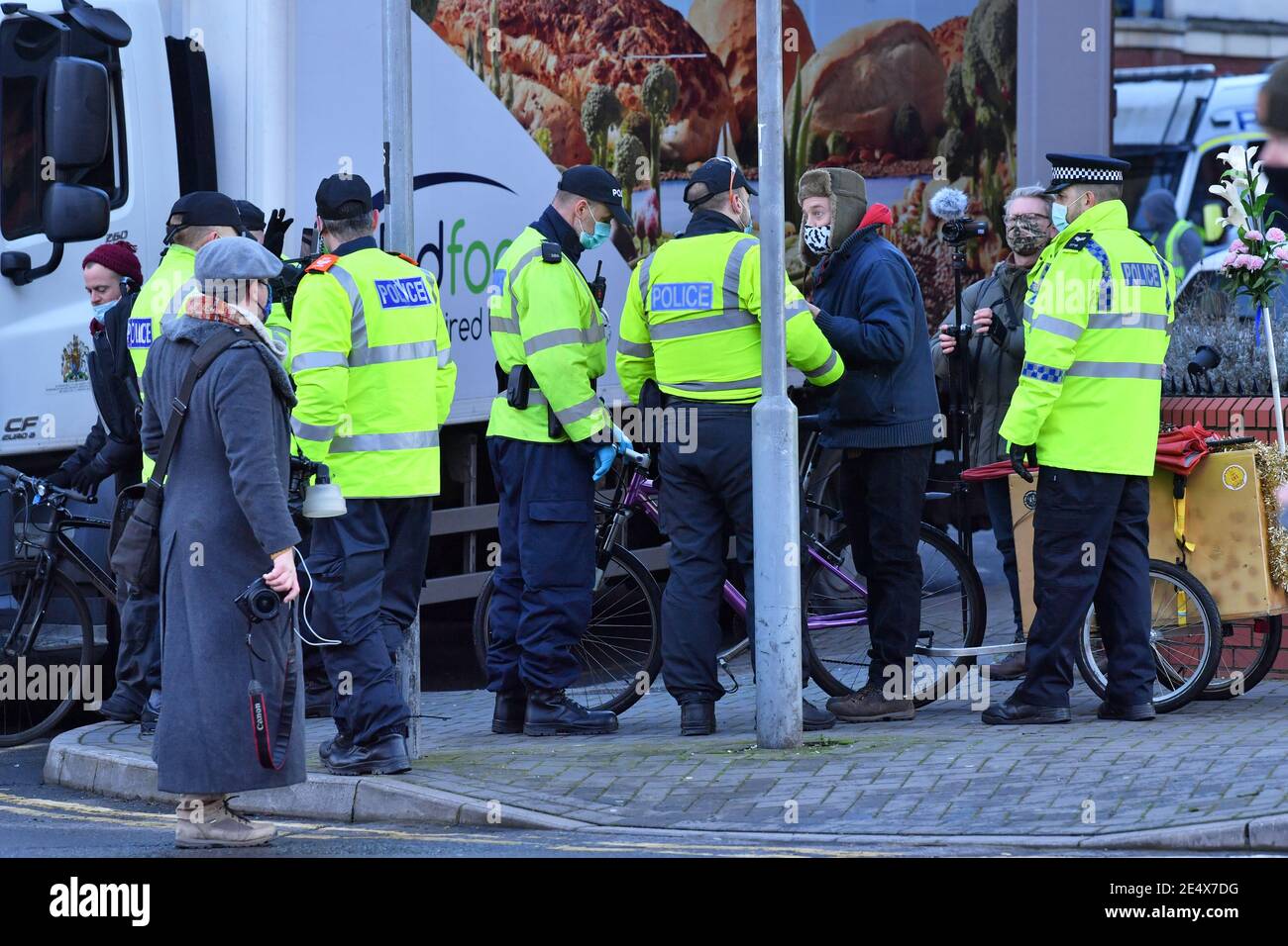 Police detain a cyclist who was playing music outside Bristol Magistrates' Court, where Rhian Graham, Milo Ponsford, Jake Skuse and Sage Willoughby are due to appear charged with criminal damage over the toppling of the Edward Colston statue in Bristol during the Black Lives Matter protests in June last year. Picture date: Monday January 25, 2021. Stock Photo