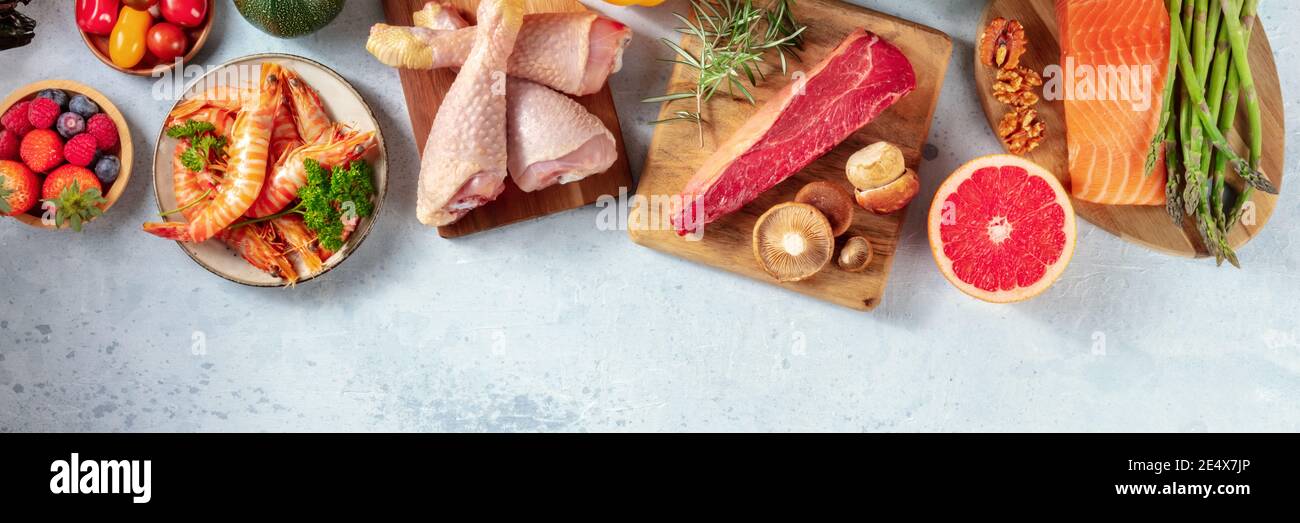 Food panorama with copy space. Meat, fish, poultry and seafood with fruit and vegetables, top shot Stock Photo