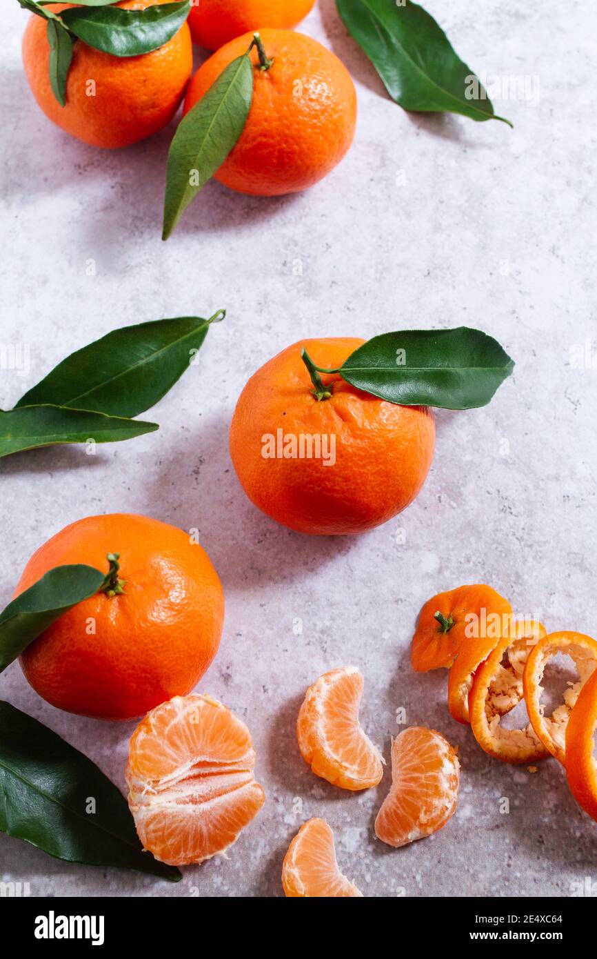 Fresh ripe mandarin oranges (clementine, tangerine) with green leaves on  retail market display, close up, high angle view Stock Photo - Alamy