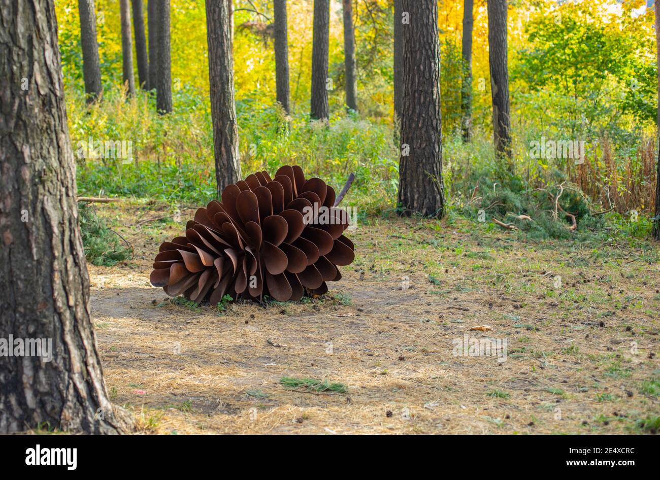 Giant metal cone, rusty metal installation in city park, pine cone ...