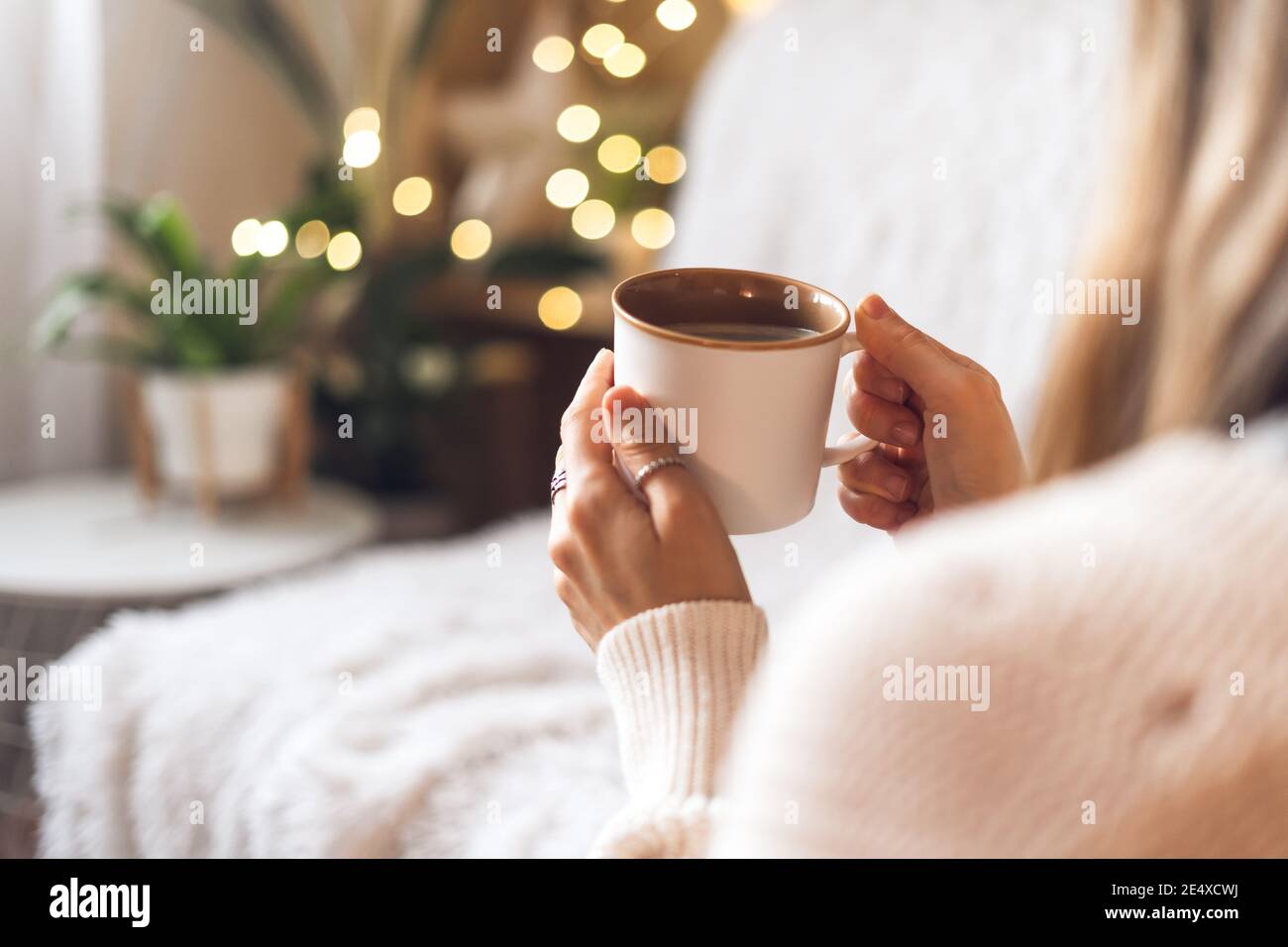 Woman's hands in sweater holding cup of coffee Stock Photo - Alamy