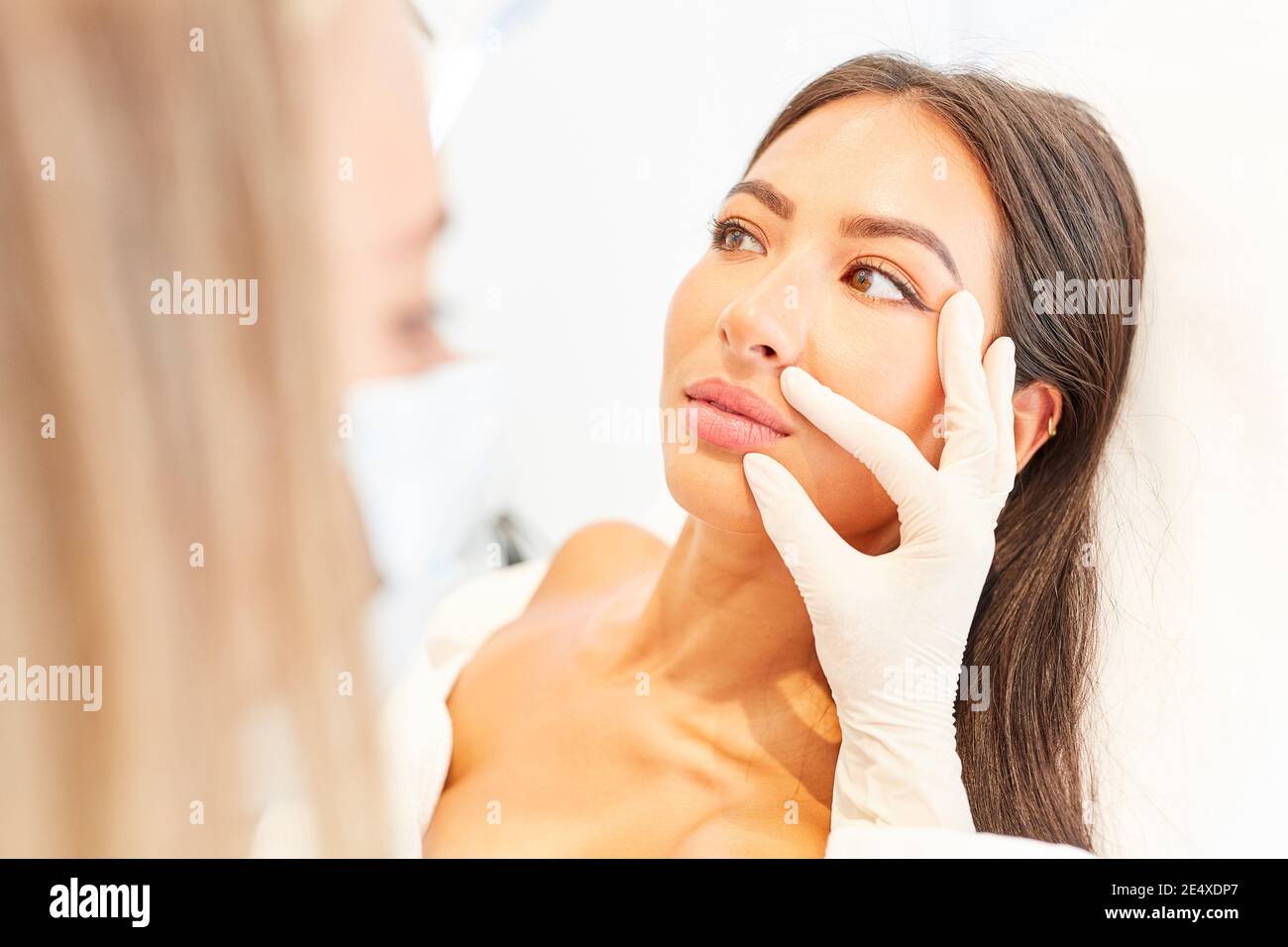 Young woman as a patient in consultation about a facelift or cosmetic surgery Stock Photo