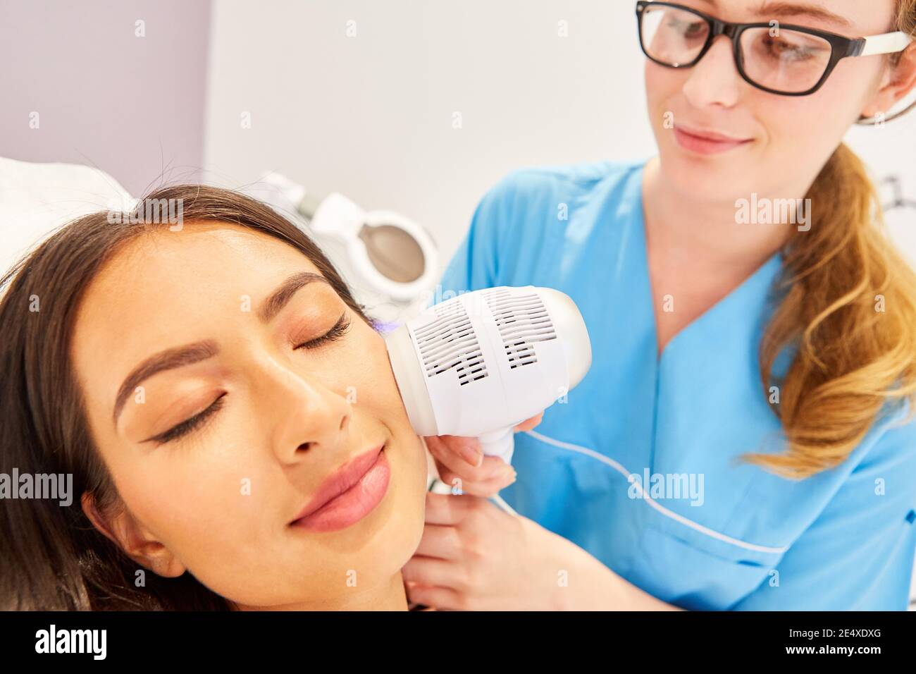 Skin tightening on a woman's face using radio frequency to create collagen in the skin Stock Photo