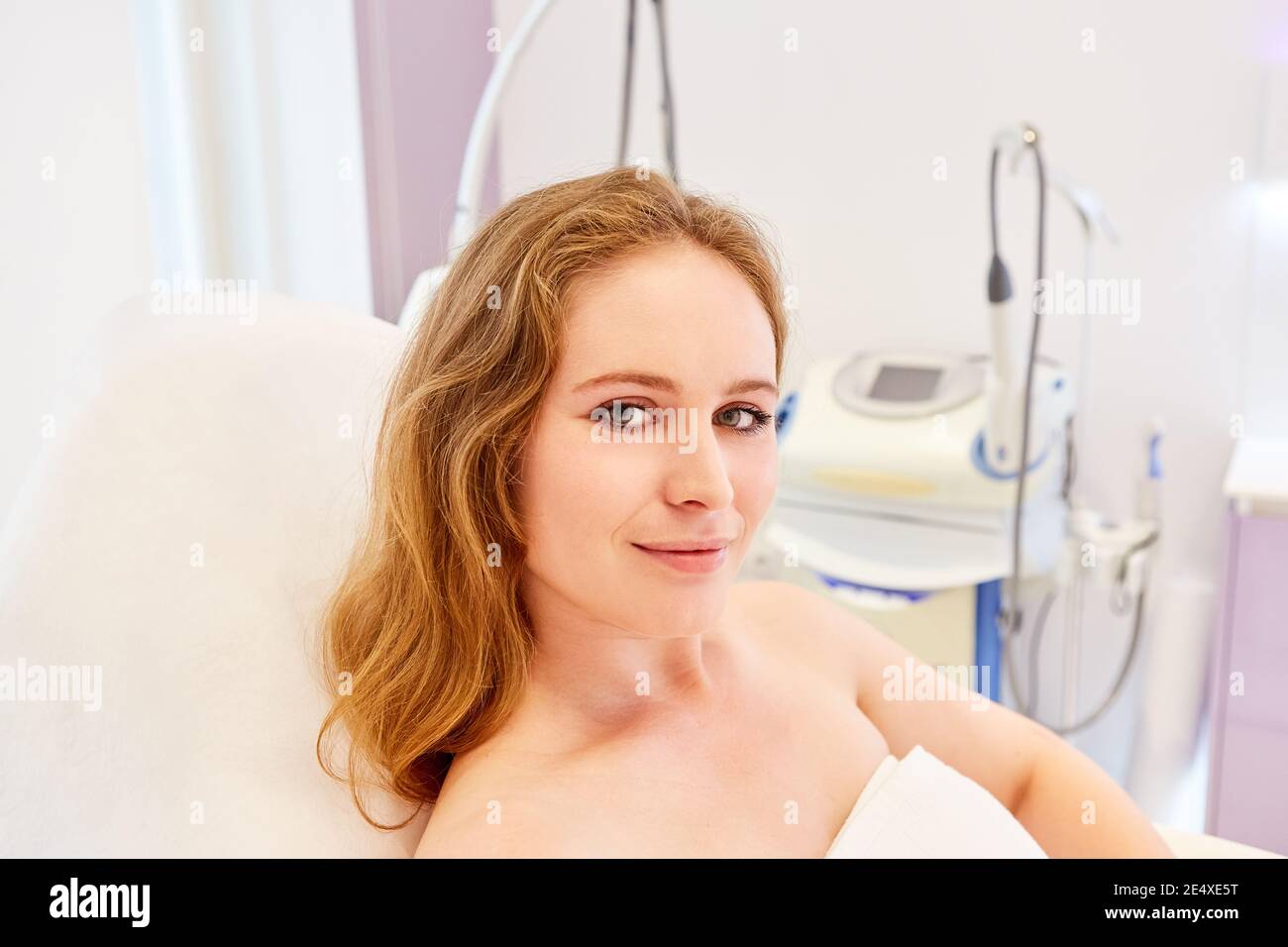 Young woman as a patient in the cosmetic studio or at the dermatologist before a treatment Stock Photo