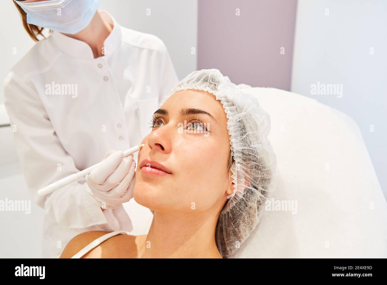 The patient receives hyaluronic acid dermal fillers to reduce wrinkles from the dermatologist Stock Photo