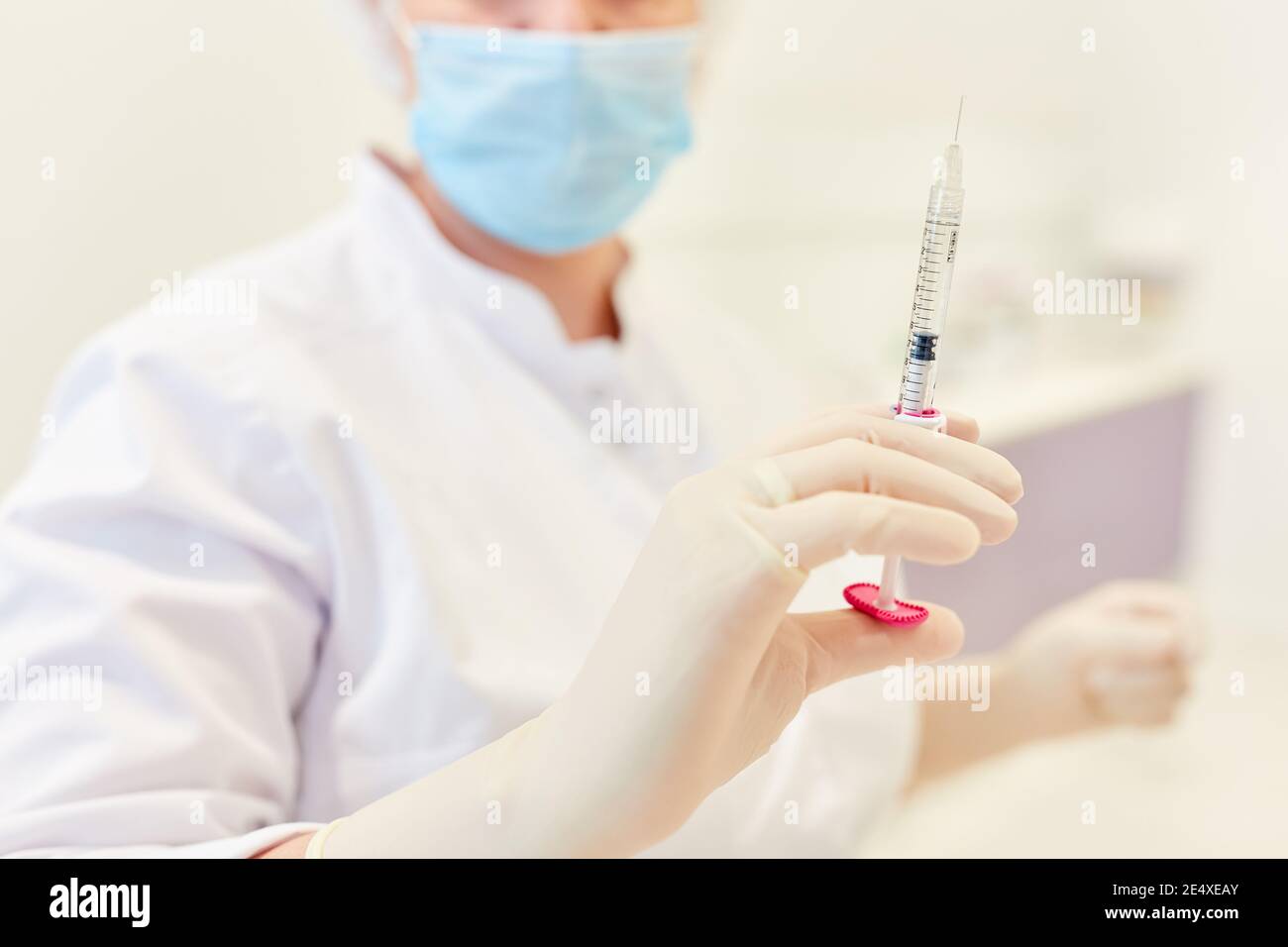Dermatologist specializing in aesthetic surgery holds a syringe with hyaluronic acid Stock Photo