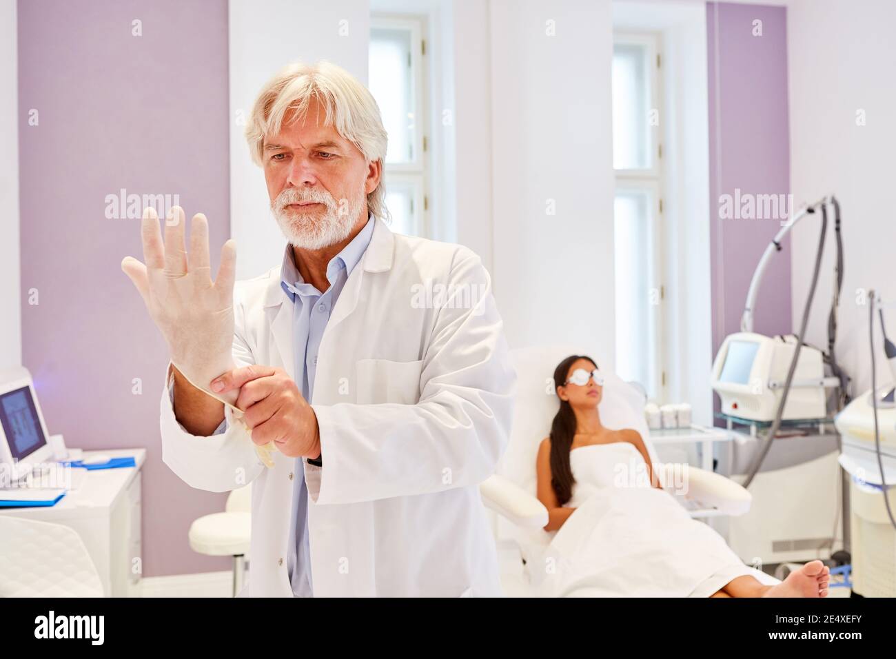 Dermatologist or beautician puts on gloves before the professional skin treatment Stock Photo
