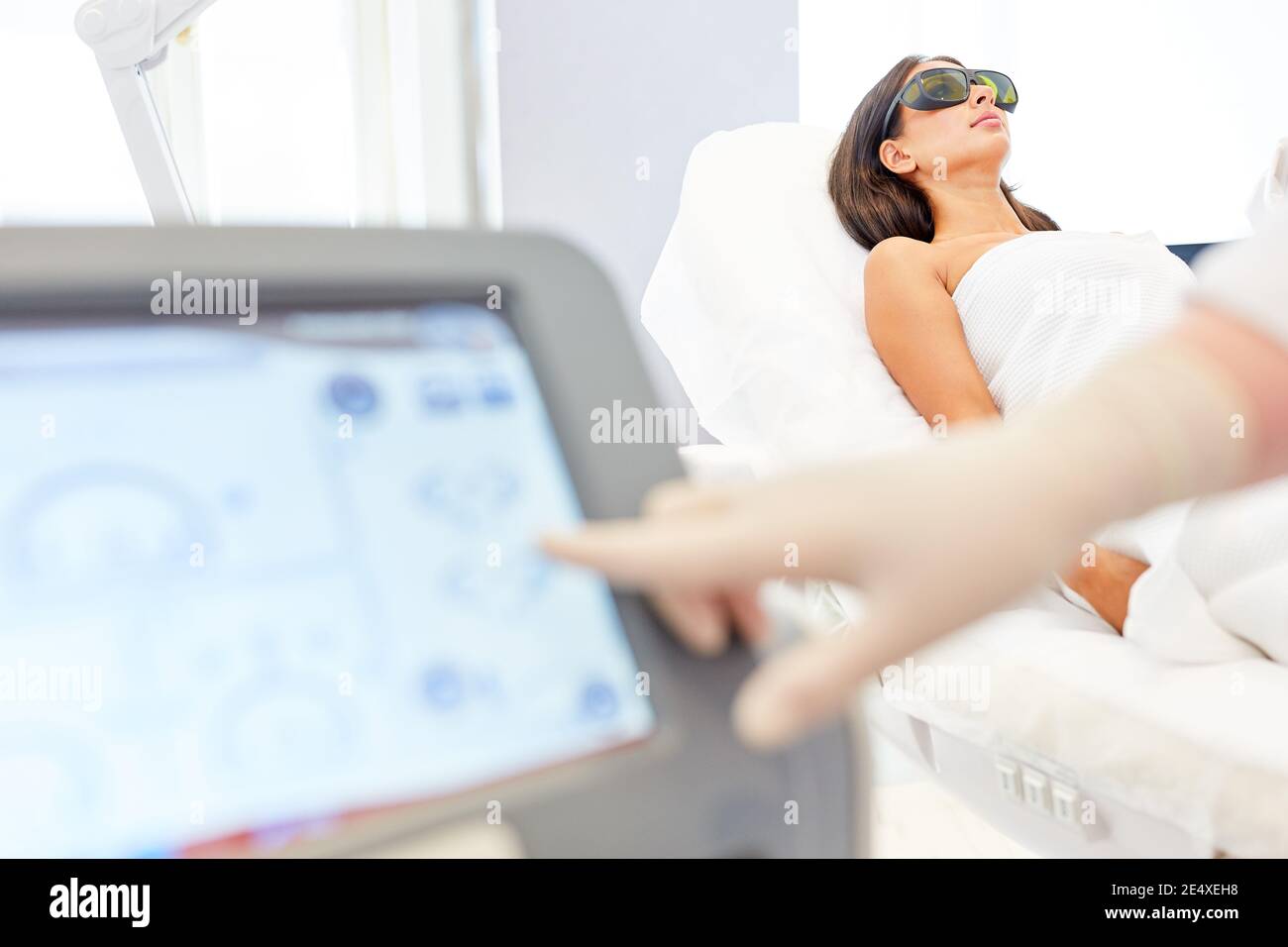 Aesthetic surgeon hand operated monitor for laser epilation Stock Photo