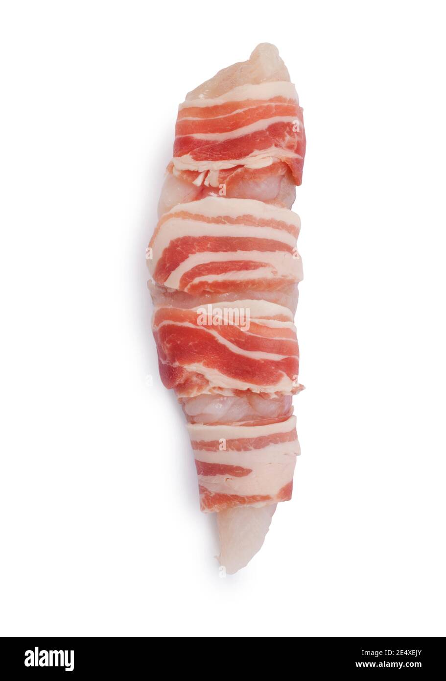Studio shot of monkfish tail wrapped in streaky bacon cut out against a white background - John Gollop Stock Photo