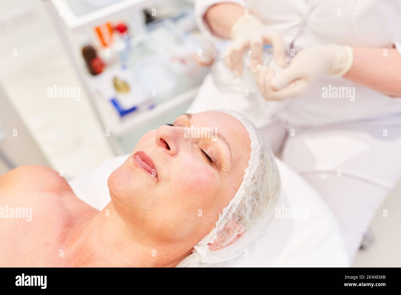 The patient lies relaxed on her back before the cosmetic surgery or facelift Stock Photo