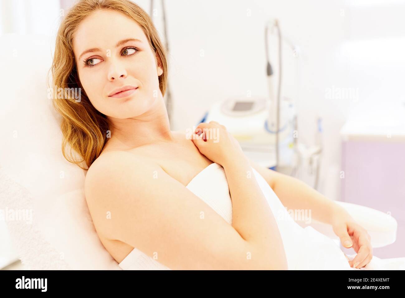 Young woman is waiting for a treatment in the beauty clinic or in the cosmetic studio Stock Photo