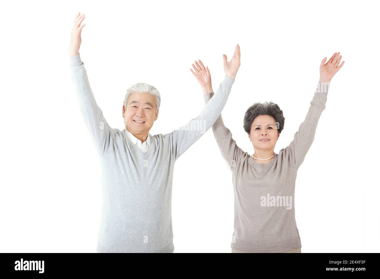 Oriental old couple with arms upraised high quality photo Stock Photo