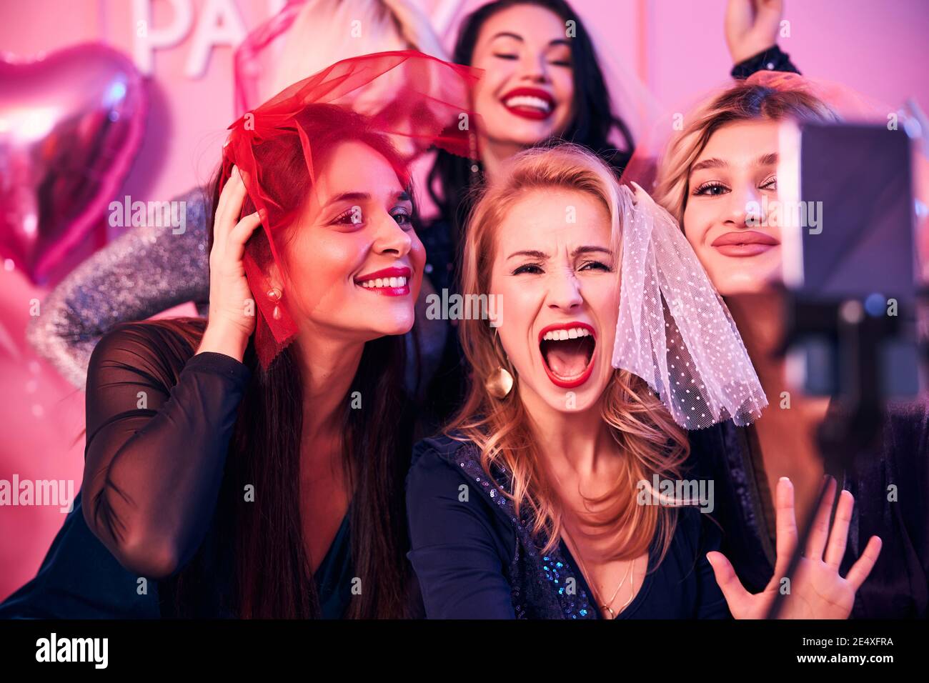 Five ladies posing for the cellphone camera Stock Photo