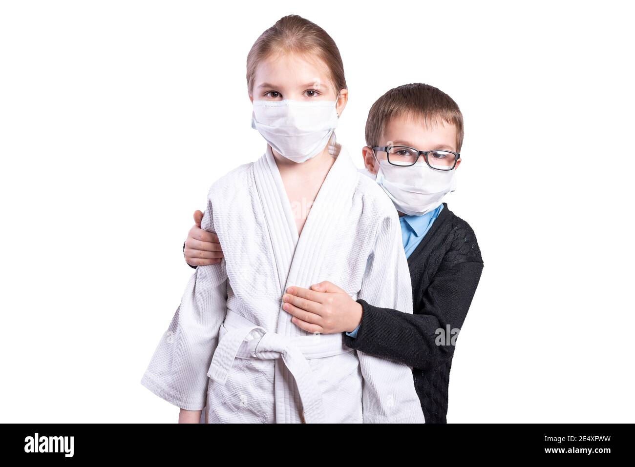 Boy schoolboy hugs a girl athlete. Masked. Isolated on white background. High quality photo Stock Photo