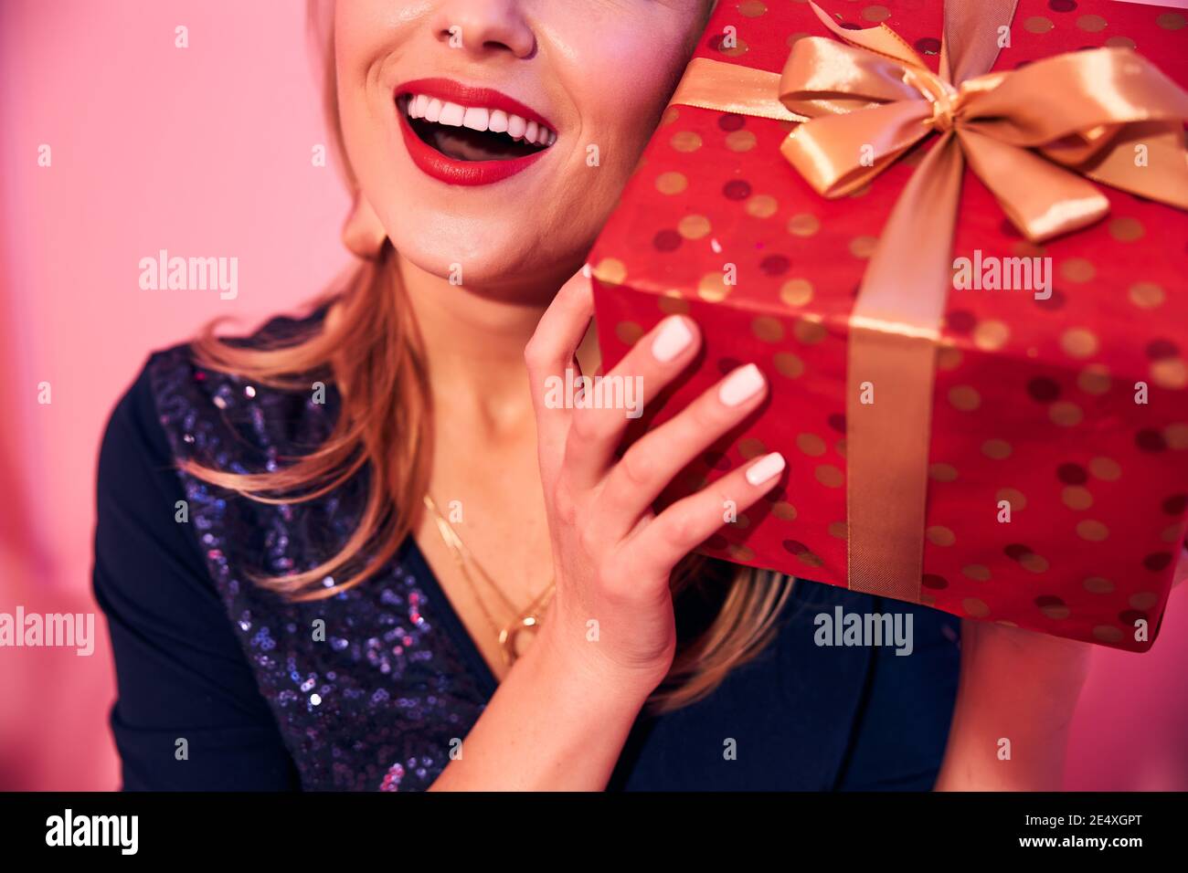 Joyous young female holding a present box Stock Photo