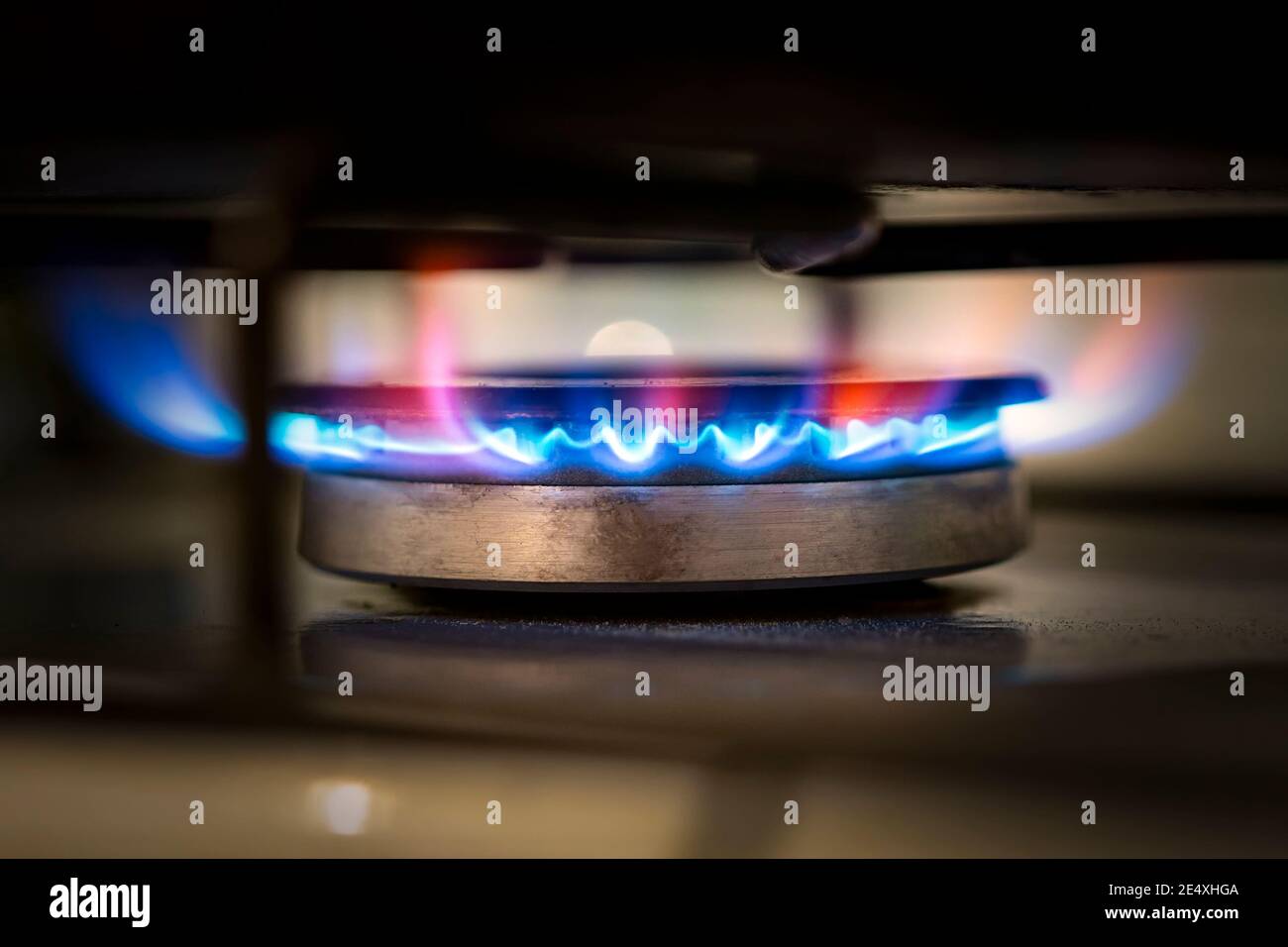 Blue propane gas burns on the kitchen gas stove. Selective focus