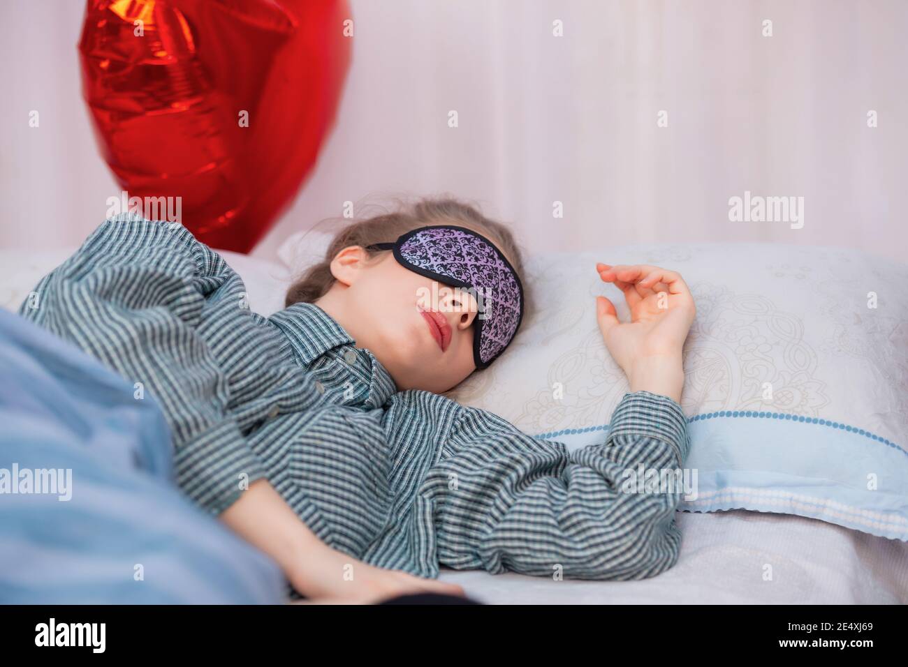 Pretty young girl wearing pajamas hires stock photography and images