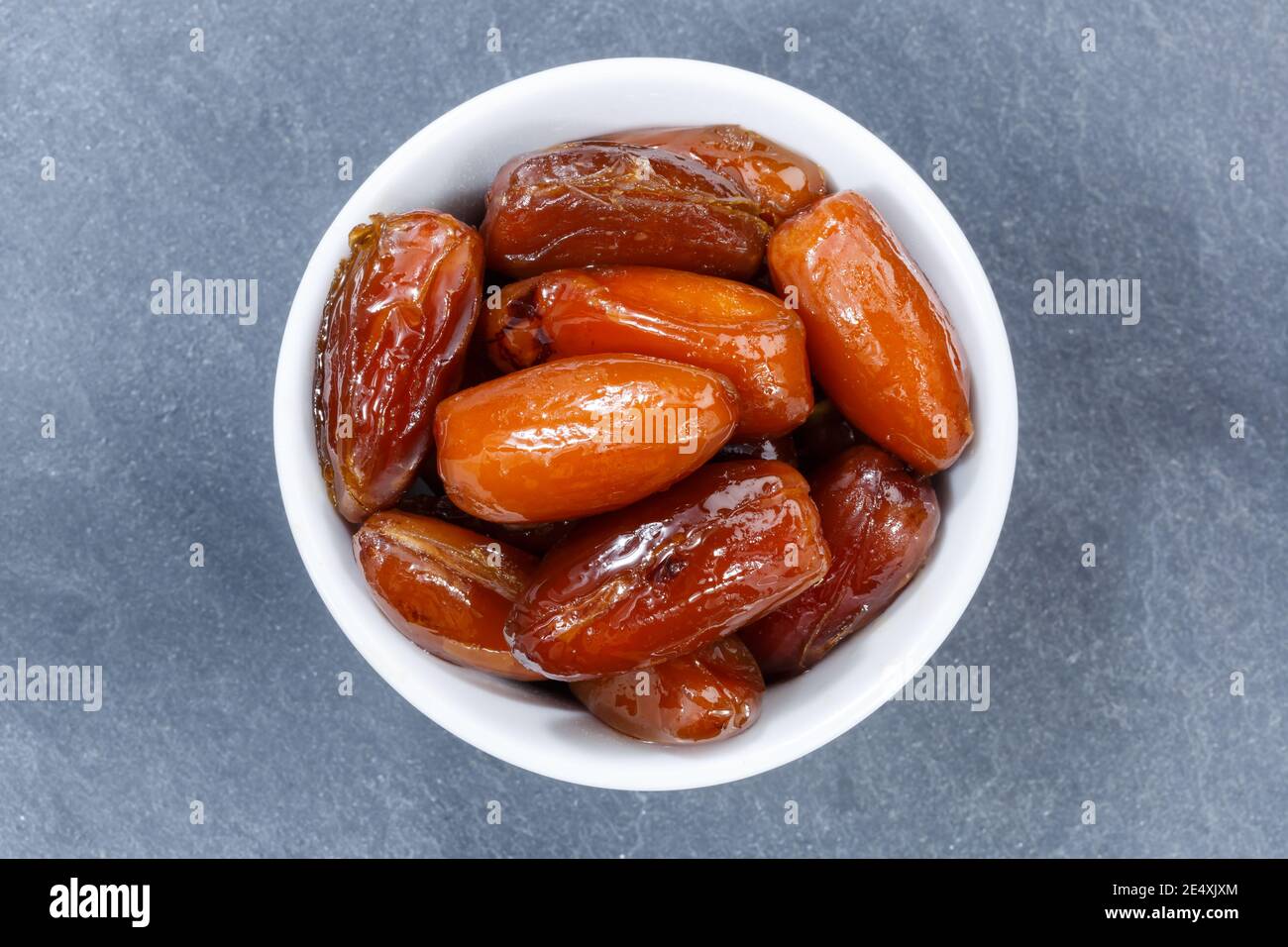 Dates fruit date from above bowl on a slate Stock Photo