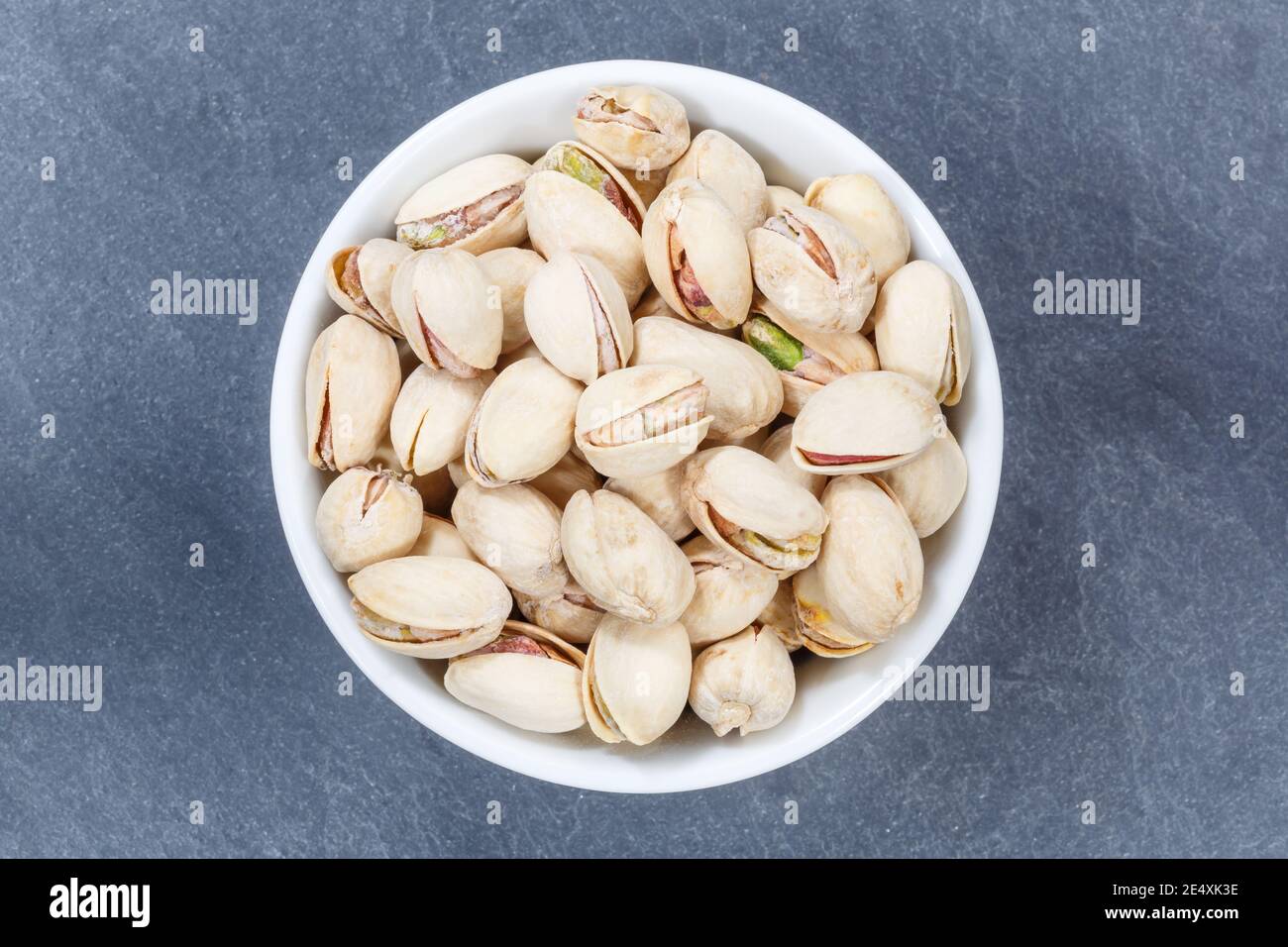 Pistachios pistachio nuts from above bowl on a slate Stock Photo