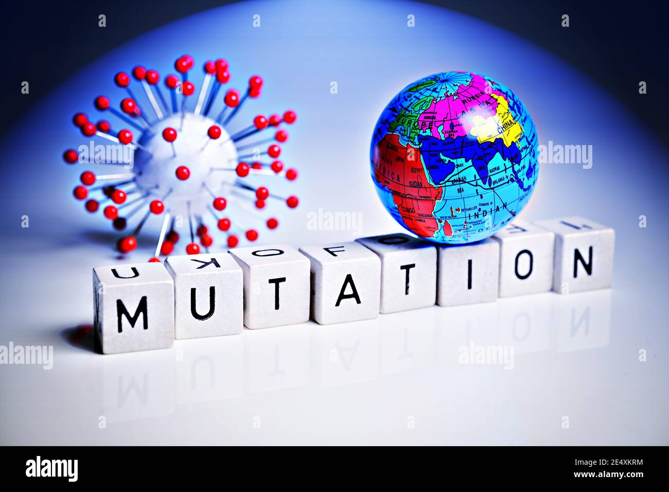 Coronavirus model, globe and letter cubes, covid mutation Stock Photo