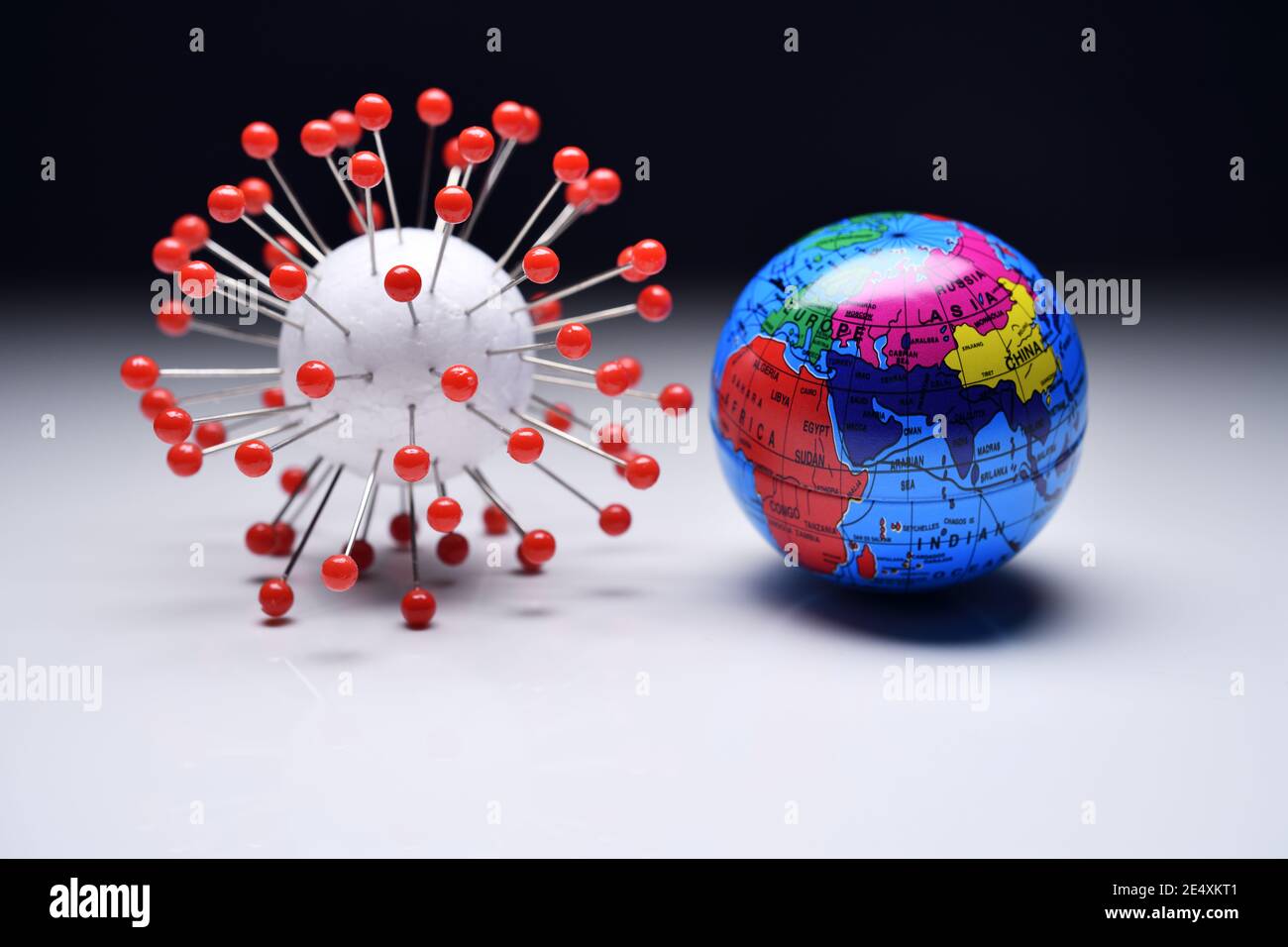 Coronavirus model and globe, covid pandemic Stock Photo