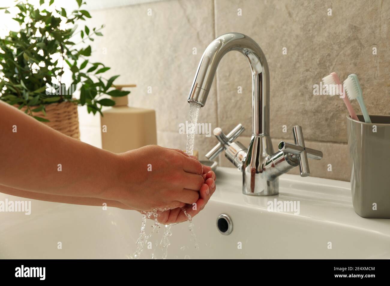 Woman washing hands under the water tap in sink Stock Photo - Alamy
