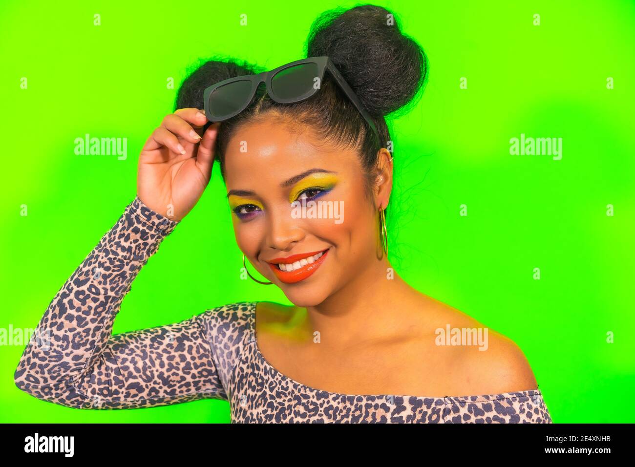Young hipster girl with bright makeup and two tails hairstyle holding  sunglasses on her head Stock Photo - Alamy