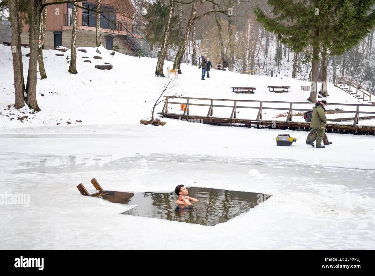 Boy or man bathing and swimming in the cold water of a lake or river