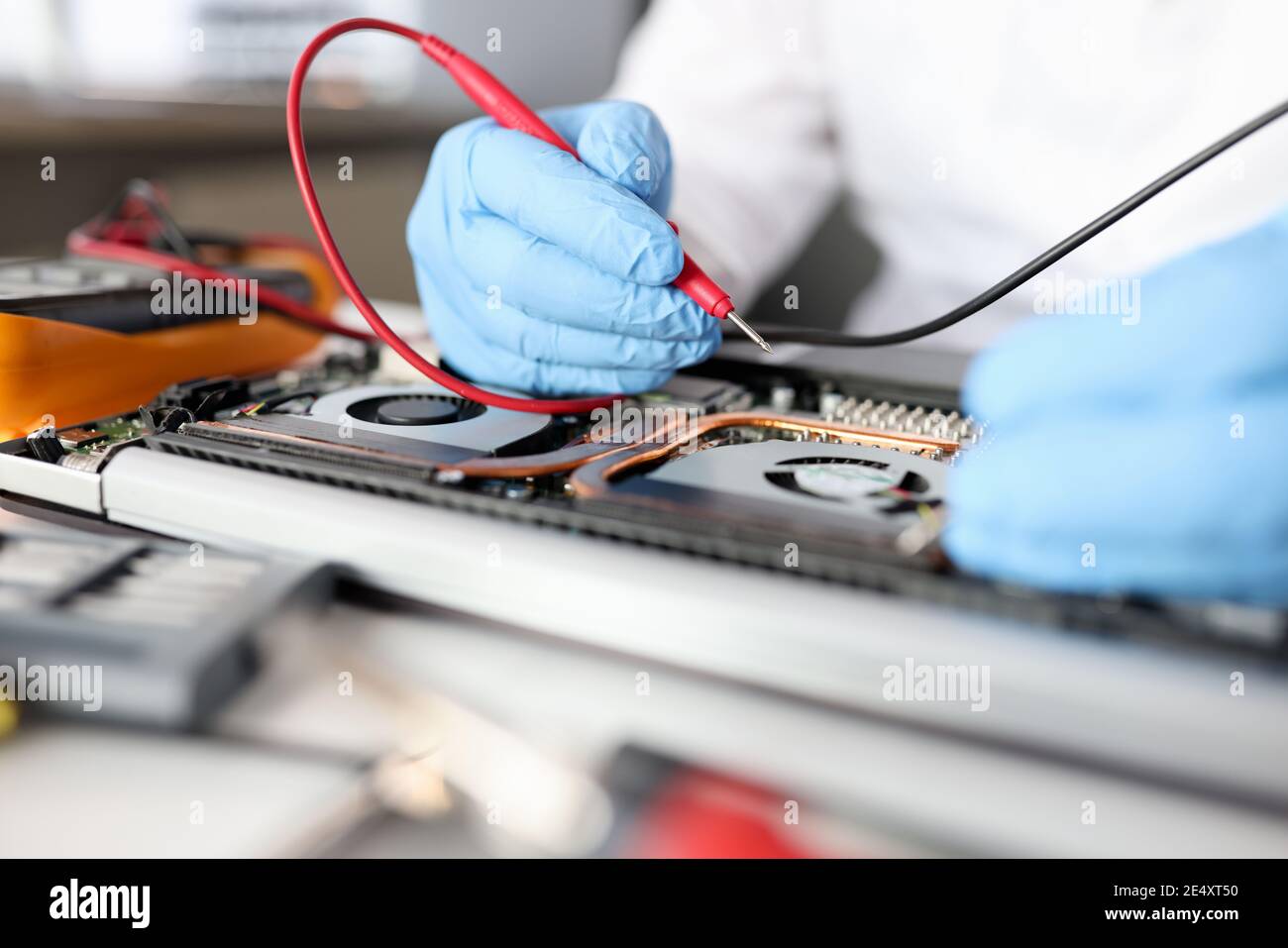 Gloved handyman repairs motherboard. Maintenance and repair of computer